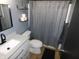Clean bathroom featuring a modern sink, toilet, shower, and stylish shelving at 1612 Prairieview Ln, Greenfield, IN 46140