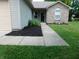 Inviting front entrance with a concrete walkway and attractive landscaping at 1612 Prairieview Ln, Greenfield, IN 46140