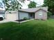 Charming single-story home with a well-maintained lawn, attached garage, and inviting curb appeal at 1612 Prairieview Ln, Greenfield, IN 46140
