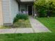 Landscaped front yard with an walkway and flowers at 1612 Prairieview Ln, Greenfield, IN 46140