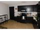 Well-equipped kitchen with sleek black appliances, ample counter space, and modern fixtures at 1612 Prairieview Ln, Greenfield, IN 46140