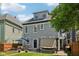 Back of gray home with a patio area, lawn, dining set, and outdoor relaxation at 1616 N Delaware St, Indianapolis, IN 46202