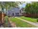Landscaped backyard with patio, dining set, lush lawn, hammock, and garden bed at 1616 N Delaware St, Indianapolis, IN 46202