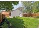 Manicured lawn leads to the detached garage and a charming, fenced-in backyard at 1616 N Delaware St, Indianapolis, IN 46202