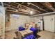 Unfinished basement with exposed brick walls and ceiling offers potential for customization at 1616 N Delaware St, Indianapolis, IN 46202