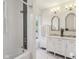 Chic bathroom with modern fixtures, a soaking tub, white marble floors, and updated vanity at 1616 N Delaware St, Indianapolis, IN 46202