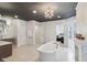 This bathroom boasts a freestanding tub, dual vanities, and herringbone tile, with a shower to the side at 1616 N Delaware St, Indianapolis, IN 46202
