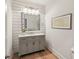 Stylish powder room featuring shiplap walls, a modern vanity, and wood-look flooring at 1616 N Delaware St, Indianapolis, IN 46202