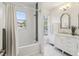 Bright bathroom showcasing a tub/shower, white vanity, and elegant fixtures, offering a spa-like retreat at 1616 N Delaware St, Indianapolis, IN 46202