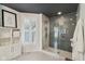 Detailed bathroom with a patterned glass shower enclosure, white shelving, and a bright shuttered window at 1616 N Delaware St, Indianapolis, IN 46202