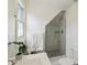 Bright bathroom with a glass enclosed shower, a white vanity, and a stylishly decorated wall at 1616 N Delaware St, Indianapolis, IN 46202