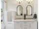 Stylish bathroom featuring double sinks with marble counters, white cabinetry, and decorative mirrors at 1616 N Delaware St, Indianapolis, IN 46202