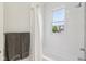 Bright bathroom with subway tile, tub/shower, and a large window letting in natural light at 1616 N Delaware St, Indianapolis, IN 46202