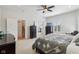 Spacious primary bedroom with neutral tones, ceiling fan, and staircase access at 1616 N Delaware St, Indianapolis, IN 46202