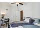 Cozy bedroom boasts ample space, ceiling fan, desk, and inviting decor for relaxation and productivity at 1616 N Delaware St, Indianapolis, IN 46202