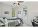 Bright bedroom featuring large windows, providing natural light and views, furnished with desk and comfortable bed at 1616 N Delaware St, Indianapolis, IN 46202