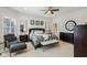 Well-lit primary bedroom featuring a decorative bed frame, sitting area, and dual mirrors at 1616 N Delaware St, Indianapolis, IN 46202