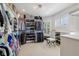Large walk-in closet with custom shelves, a bench, abundant storage, and a window with natural light at 1616 N Delaware St, Indianapolis, IN 46202