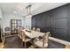 Dining room with decoratively paneled feature wall, seating for eight, and modern chandelier at 1616 N Delaware St, Indianapolis, IN 46202