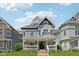 Charming gray two-story home featuring a welcoming front porch and professionally landscaped front yard at 1616 N Delaware St, Indianapolis, IN 46202