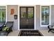 Elegant double front door with glass panels, welcome mat, and stylish exterior details and seating at 1616 N Delaware St, Indianapolis, IN 46202