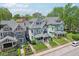 Aerial view of the front exterior showcases the landscaped yard, covered porch, and neighborhood proximity at 1616 N Delaware St, Indianapolis, IN 46202