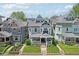 Aerial view of the front exterior showcases the landscaped yard, covered porch, and neighborhood proximity at 1616 N Delaware St, Indianapolis, IN 46202
