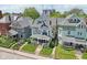 Aerial view of the front exterior showcases the landscaped yard, covered porch, and neighborhood proximity at 1616 N Delaware St, Indianapolis, IN 46202