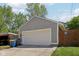 View of the detached two car garage with gray siding and a concrete driveway at 1616 N Delaware St, Indianapolis, IN 46202