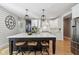 Kitchen featuring a large island with barstool seating, stainless appliances, and white cabinetry at 1616 N Delaware St, Indianapolis, IN 46202