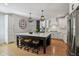 Kitchen featuring a large island with barstool seating, stainless appliances, and modern light fixtures at 1616 N Delaware St, Indianapolis, IN 46202