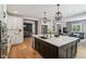 Spacious kitchen island featuring a sink, modern pendant lighting, and an open view into the living area at 1616 N Delaware St, Indianapolis, IN 46202