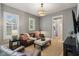 Inviting living room with gray walls, leather seating, and view to bathroom through doorway at 1616 N Delaware St, Indianapolis, IN 46202