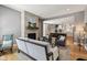 Open concept living room with stone fireplace and view into the kitchen featuring a center island at 1616 N Delaware St, Indianapolis, IN 46202