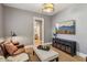 Cozy living room with gray walls, leather sofa, mounted TV, and entry to bathroom at 1616 N Delaware St, Indianapolis, IN 46202