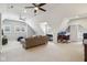 Large, carpeted living area with multiple ceiling fans, a desk, and a comfortable sofa at 1616 N Delaware St, Indianapolis, IN 46202