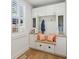 Charming mudroom with built-in bench, storage cabinets, natural light, and stylish decor at 1616 N Delaware St, Indianapolis, IN 46202