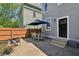 Brick paver patio with outdoor dining set, grilling area, and nearby back door at 1616 N Delaware St, Indianapolis, IN 46202