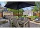 Backyard patio featuring an outdoor dining area, grill, and comfortable lounge area at 1616 N Delaware St, Indianapolis, IN 46202