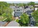 Aerial view of the home's back exterior featuring a patio, well-kept lawn, and mature trees for backyard privacy at 1616 N Delaware St, Indianapolis, IN 46202