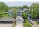 Aerial view of the home's back exterior and detached two-car garage surrounded by a wood fence, grass, and trees at 1616 N Delaware St, Indianapolis, IN 46202