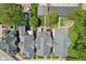Overhead aerial view of the home's back exterior showcasing the patio, lawn, detached garage, and tree coverage at 1616 N Delaware St, Indianapolis, IN 46202