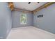 Bedroom featuring decorative wooden shelving, neutral carpet, and a window at 16768 Maraschino Dr, Noblesville, IN 46062