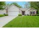 Charming single-story home with a manicured lawn, attached garage, and inviting front entrance at 16768 Maraschino Dr, Noblesville, IN 46062