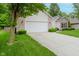 Single-story home features an attached two-car garage, lush landscaping, and a welcoming front entrance at 16768 Maraschino Dr, Noblesville, IN 46062