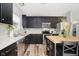 Well-lit kitchen boasts stainless appliances, black cabinetry, stylish flooring, and a butcher block island at 16768 Maraschino Dr, Noblesville, IN 46062