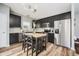 Contemporary kitchen featuring stainless steel appliances, black cabinets, kitchen island, and wood-look flooring at 16768 Maraschino Dr, Noblesville, IN 46062
