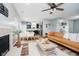 Bright living room showing seamless flow into dining area and kitchen, hardwood floors, and modern lighting at 16768 Maraschino Dr, Noblesville, IN 46062