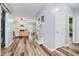 Open-concept living area with hardwood floors, neutral paint, fireplace, and a view to the dining area at 16768 Maraschino Dr, Noblesville, IN 46062