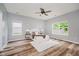 Serene main bedroom featuring wood flooring, a ceiling fan, and windows providing natural light at 16768 Maraschino Dr, Noblesville, IN 46062